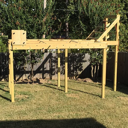 A backyard obstacle course built from wooden framing